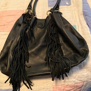 Black leather Free People Sundown Wilds with fringe on the front.